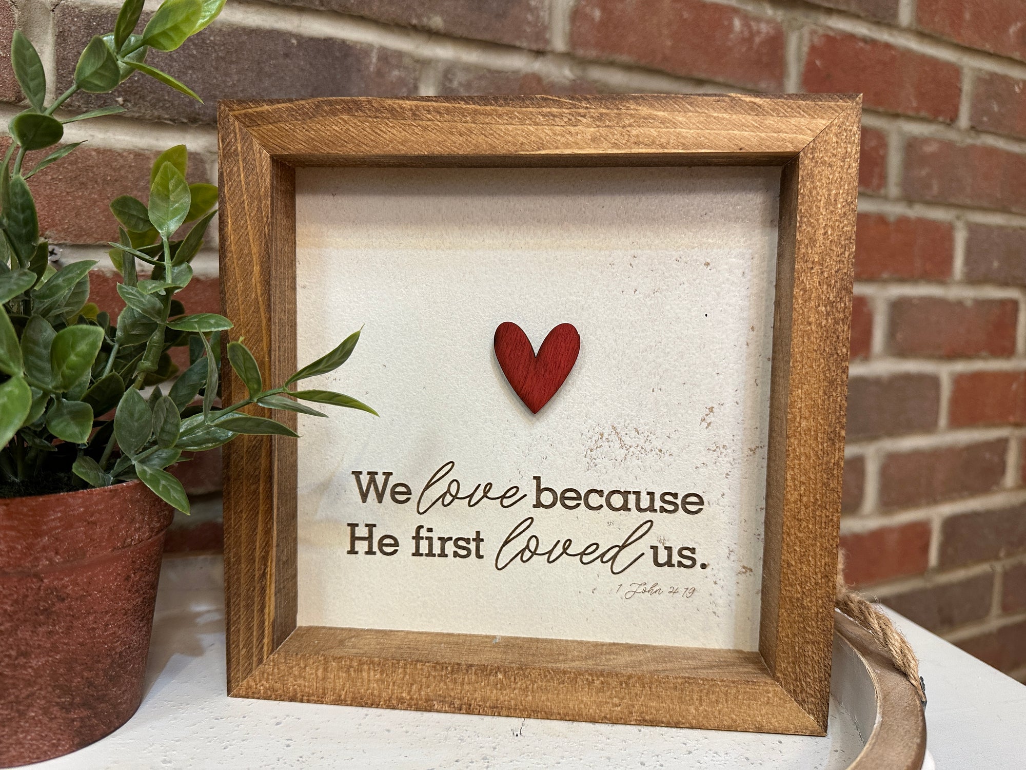 Handmade We Love Because he first loved us framed sign